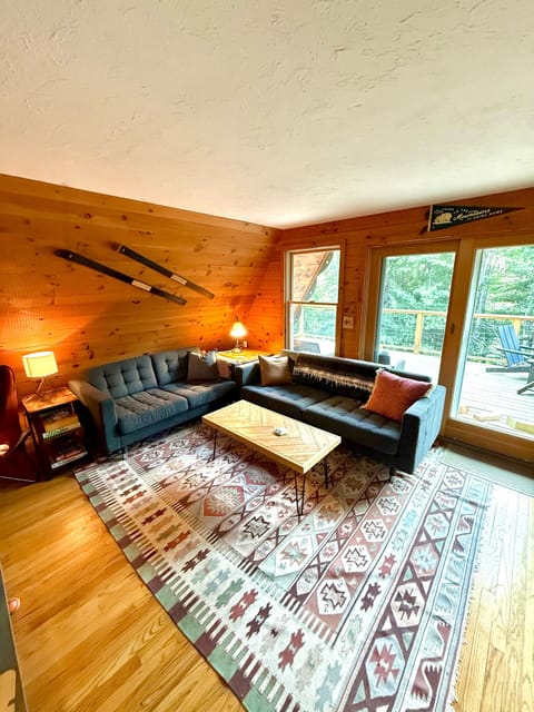 Enjoy plenty of seating in the cozy living room with a wood burning fireplace.