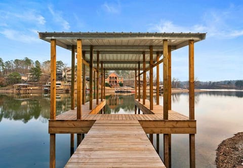 The private dock stretches out over Lake Hamilton, offering an inviting spot for fishing, boating, or simply soaking in the calm water and scenic surroundings.