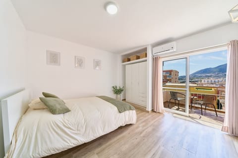 Spacious bedroom and balcony with a view