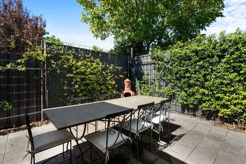 Share relaxed meals outdoors at the large dining table beneath open skies.