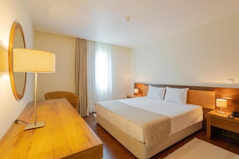 Unwind in a serene bedroom with crisp linens and warm light.