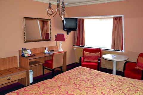 Unwind in a warm, classic room with cozy seating.