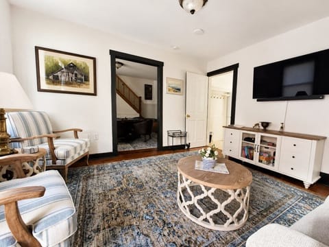 Bright and cozy living room with coastal decor and a large flat screen Smart TV