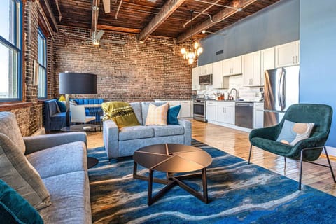 Living Room: Experience urban charm with exposed brick, modern decor, and plenty of natural light!