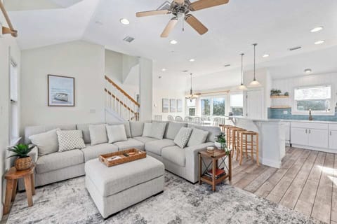 A bright and comfortable gathering space with a large sectional and ottoman, additional chairs, and a big TV for movie nights. Open to the kitchen and dining area, it’s the perfect place to relax, play games, and spend time together.