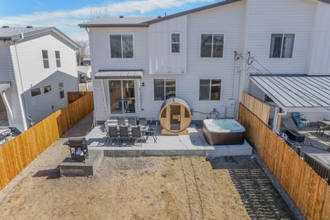 The patio comes fully loaded with dining table, grill, sauna, and hot tub