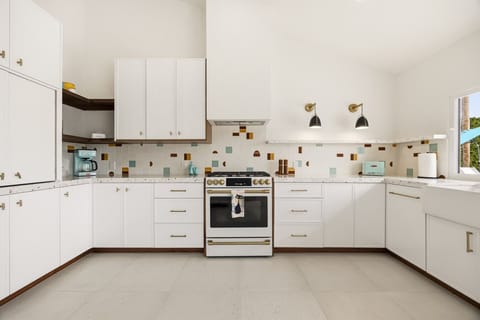 Fully equipped kitchen featuring custom tile and fun mid-century details.