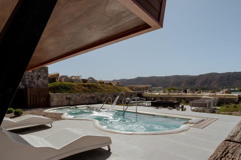 Sink into the bubbling hot tub beside modern glass walls.