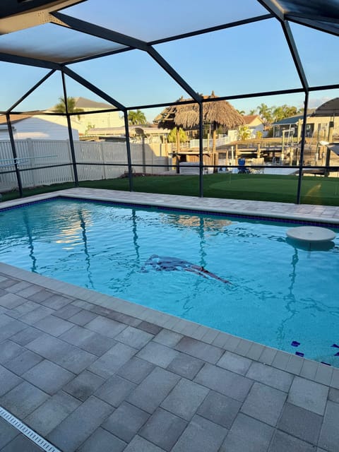 Your private screened pool offers the perfect retreat with tropical tiki bar views in your own backyard paradise.