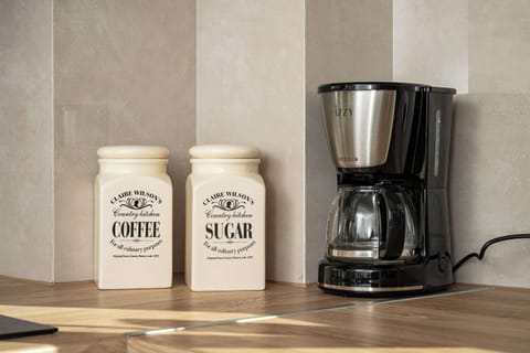 Coffee station and kitchen details thoughtfully arranged.