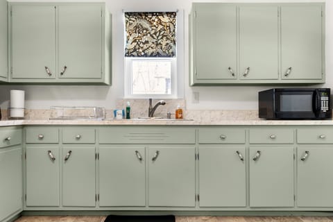 Fully equipped kitchen with ample cabinets for easy home cooking.