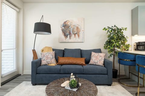 Inviting living room with a pull-out couch, a comfy chair and a flat-screen TV—perfect for relaxing or entertaining.