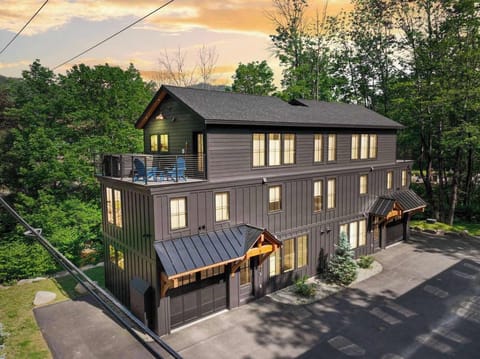 The charcoal board-and-batten exterior and timber-framed entryways give you a sense of what's inside before you even open the door.