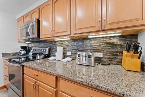 Full kitchen with stainless steel appliances.