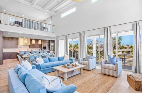 Relax in your stunning great room where soaring ceilings and ocean blues create the perfect coastal retreat for memorable gatherings.