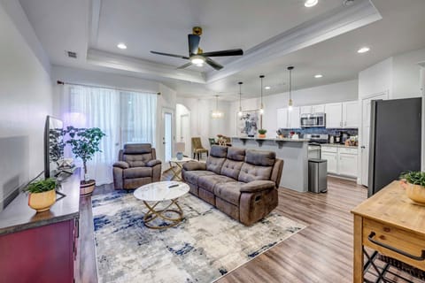Spacious open-concept living area with comfortable seating and smart TV.