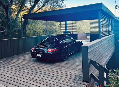In tree canopy, chic carport, with EV charger, leads to the gorgeous terrace