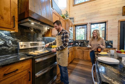 This chef`s kitchen features custom wood cabinetry, marble countertops, and stainless steel appliances perfect for preparing meals during your stay.