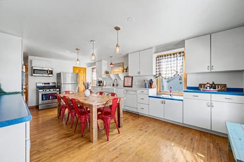 Kitchen Delight: Bright and airy kitchen with bold red chairs, perfect for gatherings and meals!