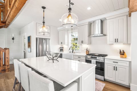 Prepare a family meal in this well-appointed kitchen featuring a large stainless steel refrigerator and premium gas range