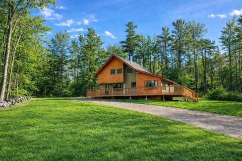 Private four-bedroom retreat set on a quiet, wooded lot in the desirable Gunstock Acres neighborhood, with a wraparound deck and plenty of space to unwind outdoors.