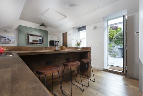 Breakfast bar in kitchen with food leading to patio - Stay Ca Holidays