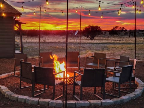 This is the moment you came for.  A crackling fire, string lights overhead, and an Arizona sunset that paints the sky in every shade of gold, orange, and red  Pure magic.