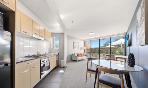 Modern kitchen with dining and balcony view