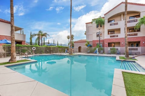 Unwind poolside with sparkling water and spacious lounge areas.