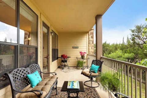 Private covered balcony with outdoor seating, peaceful views, and space to enjoy morning coffee or evening downtime.