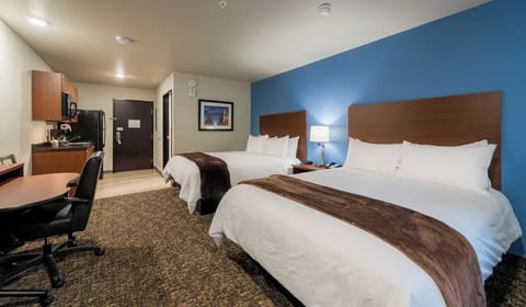 Sink into cozy double-queen beds in a calm, bright room.