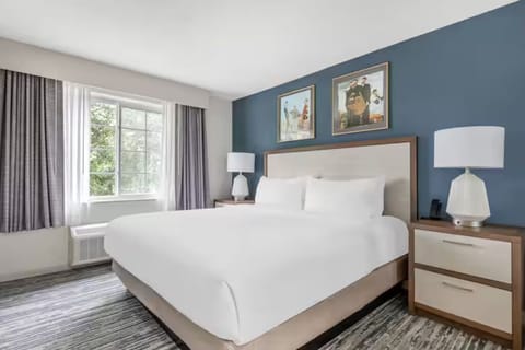 Unwind in a crisp king bed with soft light.