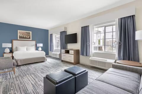 Take in the airy suite layout with bed and lounge area