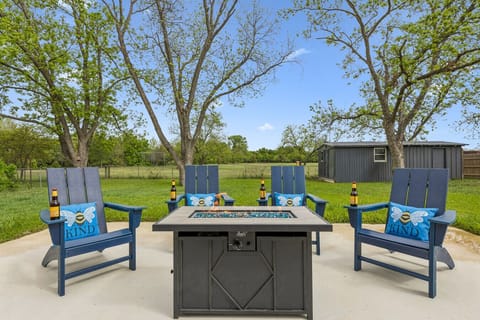 Backyard | Propane Fire Pit | Blue Adirondack Chairs & Bee Pillows