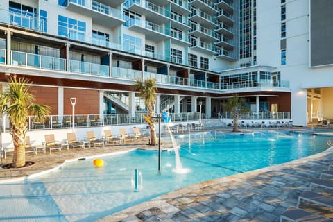 Splash into the expansive resort pool with playful fountains.