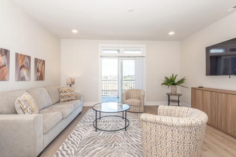 Bright, open living space with direct access to the balcony overlooking the pool