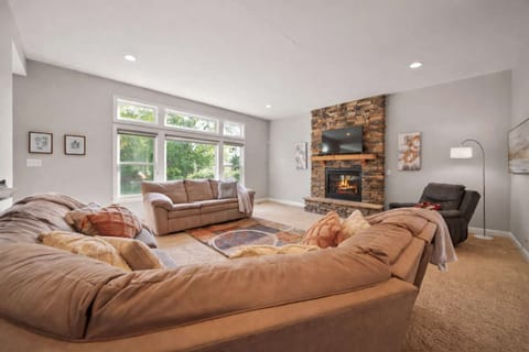 Bright living room w/ plush sectional seating & large windows filling the space w/ natural light
