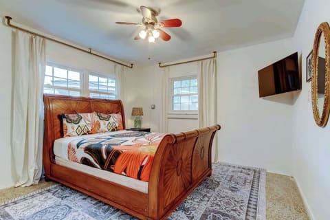 Spacious bedroom with classic wooden bed