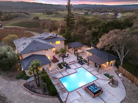 Bird’s-eye view of the illuminated pool and courtyard. (Main house)