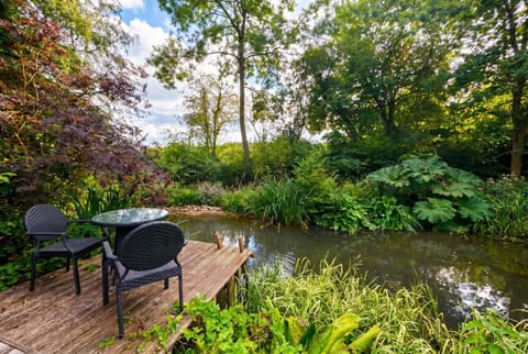 Dine or unwind on the private deck surrounded by the lush garden pond.