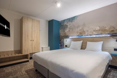 Recharge in a serene bedroom with warm lighting and plush bedding.
