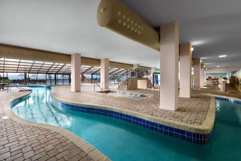 Float along the winding indoor lagoon under soft resort lighting.