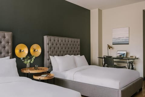 Relax in a spacious room with comfortable beds and workspace.