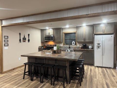 Kitchen w/ a nice sized island that seats 8. Kuerig coffee pot. Coffee provided.