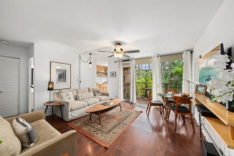 Relax in this open‑concept living area where large windows and sliding doors bring the outdoors in.