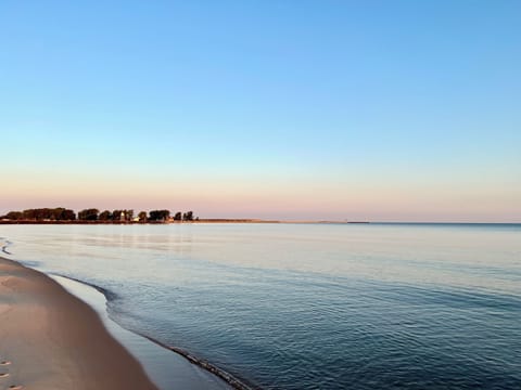 View of beautiful private beach, with the lighthouse in the distance 