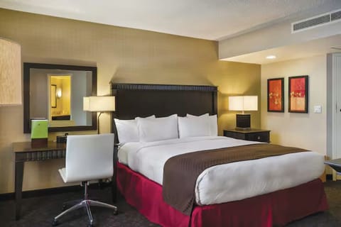 Drift off peacefully in a plush bed with warm lighting.