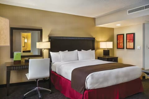 Sink into a king bed framed by warm, calming lighting.