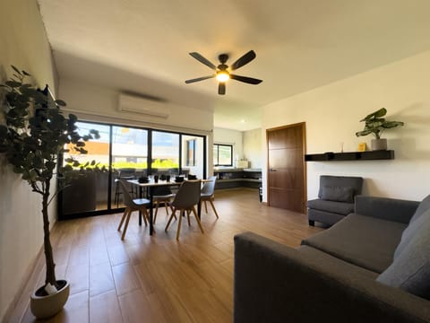 Sunlit living and dining area with scenic window views