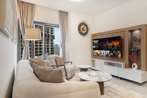Comfort meets elegance—enjoy this airy living room with skyline views, soft neutral tones, and a smart TV for entertainment.